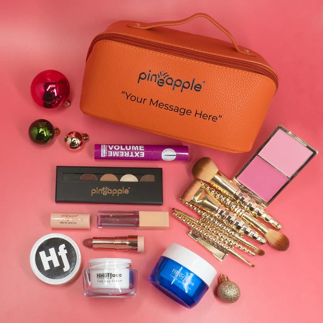 Deluxe makeup gift set laid out on pink background. 